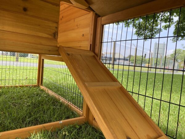 Ramp on large, natural wood rabbit hutch