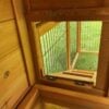 Natural wood interior of a rabbit hutch, showing ramp